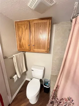a white toilet sitting next to a window