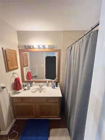 a bathroom with a sink vanity and a mirror