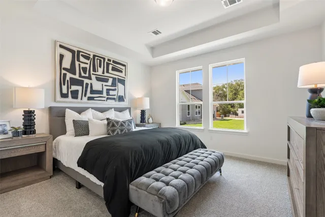 a spacious bedroom with a bed and a window