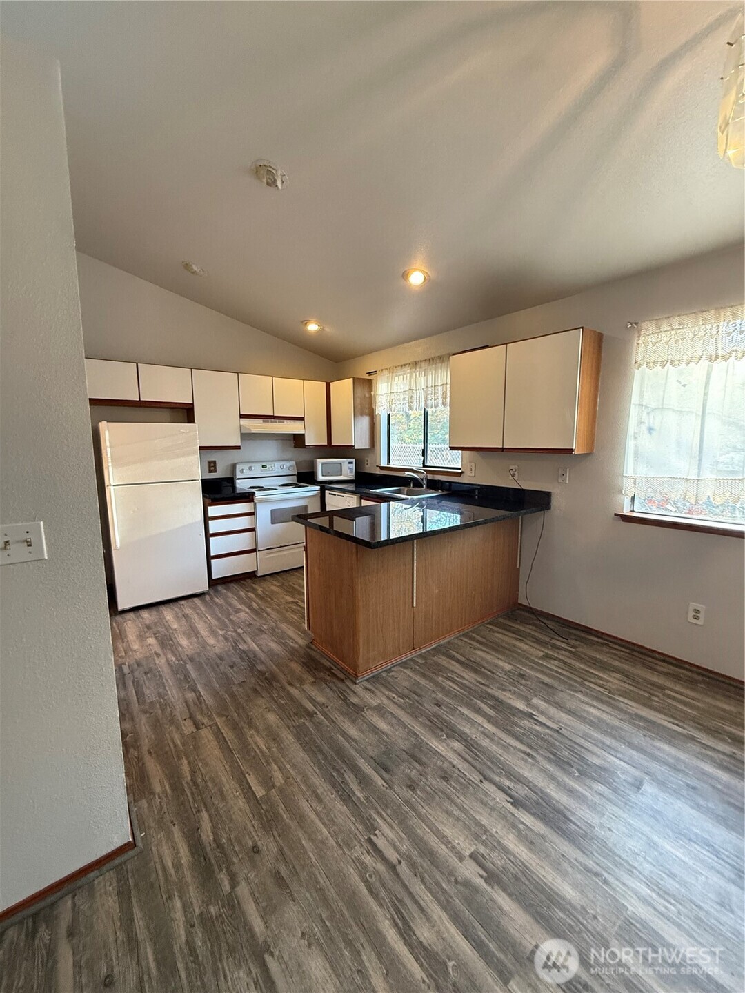 2024 Southeast 8th Drive Renton, WA 98057 - Photo 2 of 12 a kitchen with stainless steel appliances granite countertop a refrigerator sink and cabinets