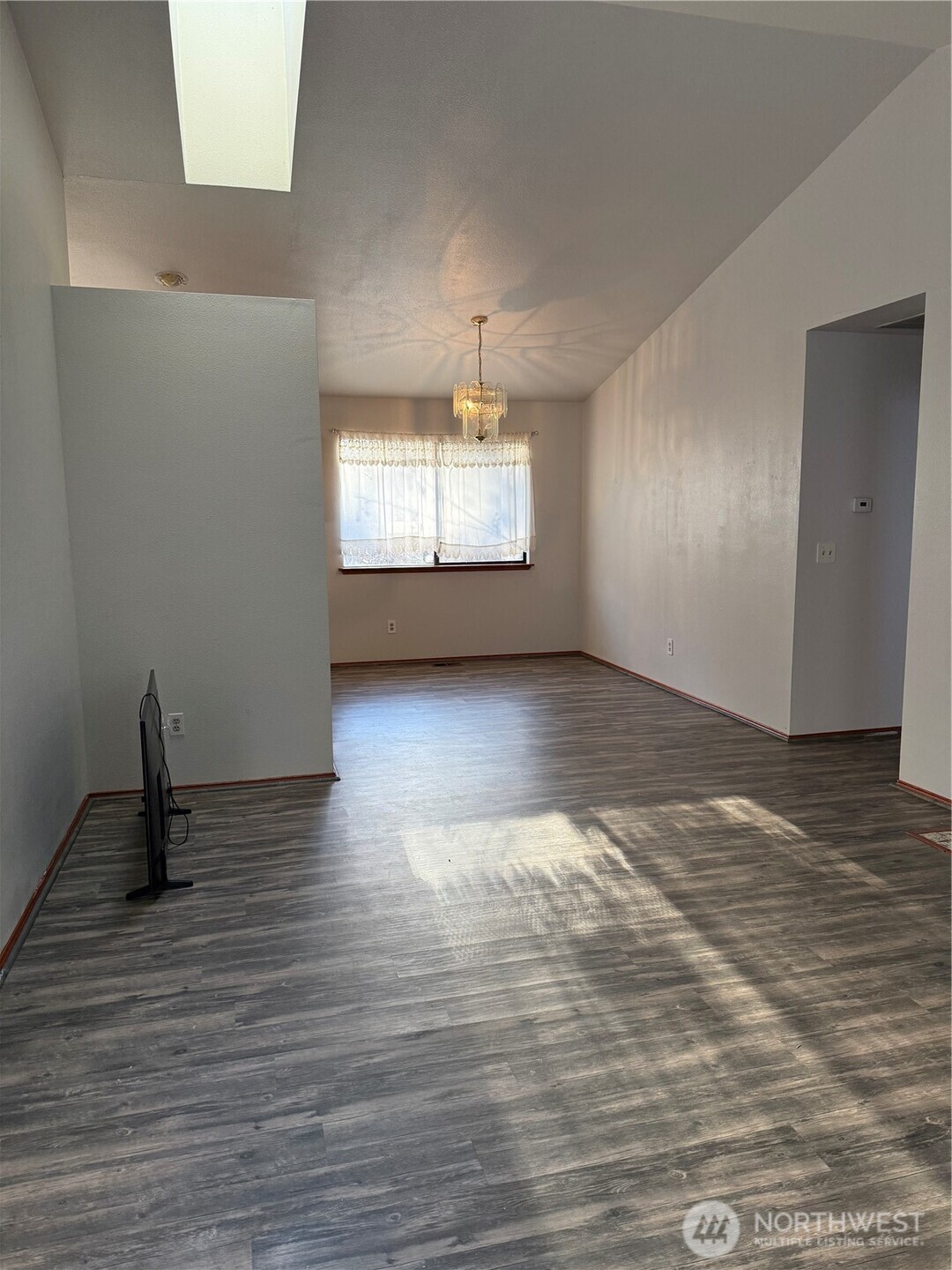 2024 Southeast 8th Drive Renton, WA 98057 - Photo 5 of 12 a view of an empty room with wooden floor and a window
