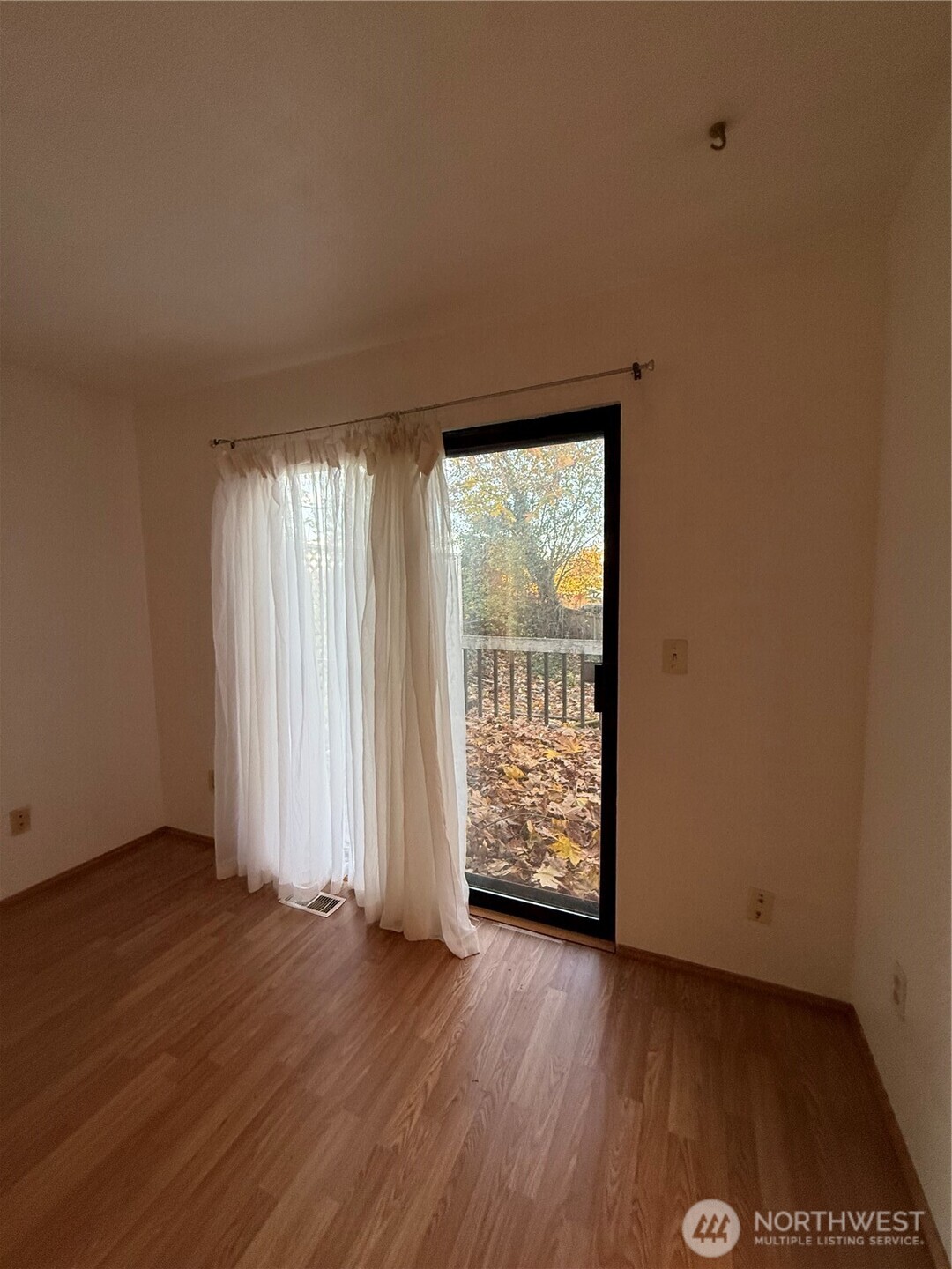 2024 Southeast 8th Drive Renton, WA 98057 - Photo 6 of 12 an empty room with wooden floor and windows