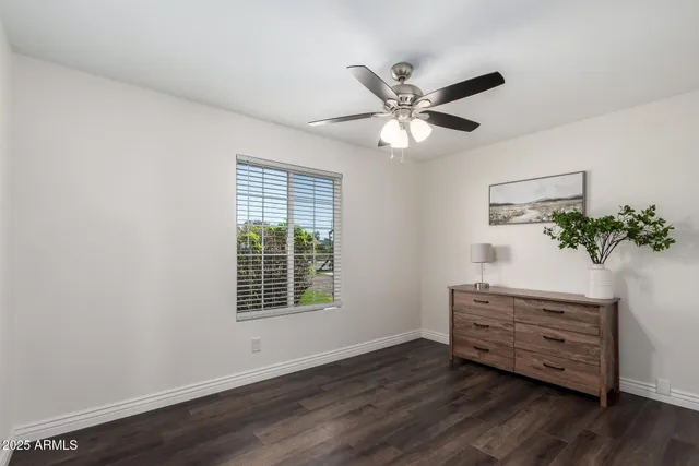 a view of a room with wooden floor and potted plant