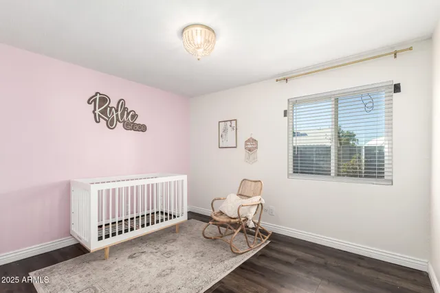 a view of a room with a window and wooden floor
