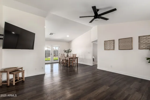 a view of a livingroom with furniture and a flat screen tv