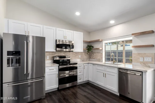 a kitchen with a refrigerator stove and sink