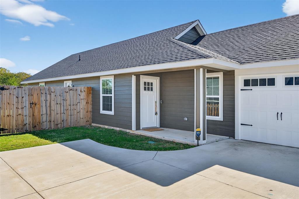 1016 Ray Drive Denison, TX 75020 - Photo 2 of 7 a front view of a house with a yard and garage