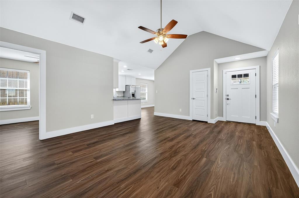 1016 Ray Drive Denison, TX 75020 - Photo 3 of 7 a view of a livingroom with wooden floor and a ceiling fan