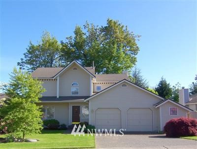 126 236th Place Southwest Bothell, WA 98021 - Photo 1 of 1 a front view of a house with a yard and garage