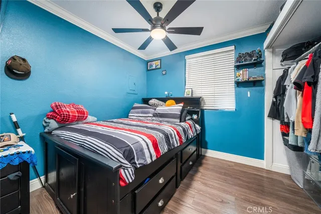 a bedroom with bed and a flat tv screen