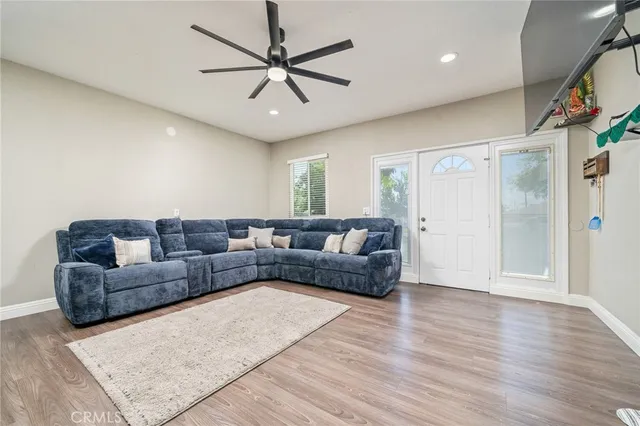 a living room with furniture and a ceiling fan