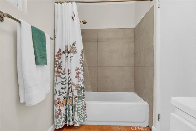 a bathroom with a bathtub and shower