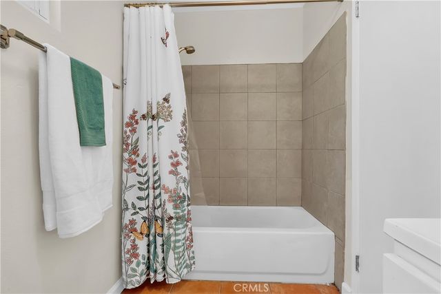 a bathroom with a bathtub and shower