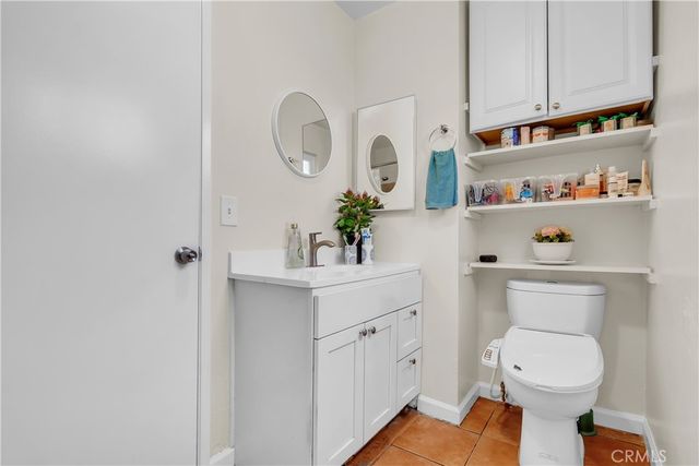 a bathroom with a toilet a sink and a mirror