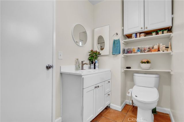 a bathroom with a toilet a sink and a mirror