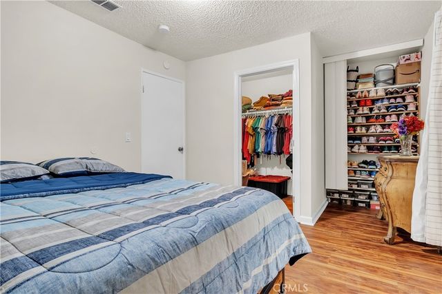 a bedroom with bed and wooden floor