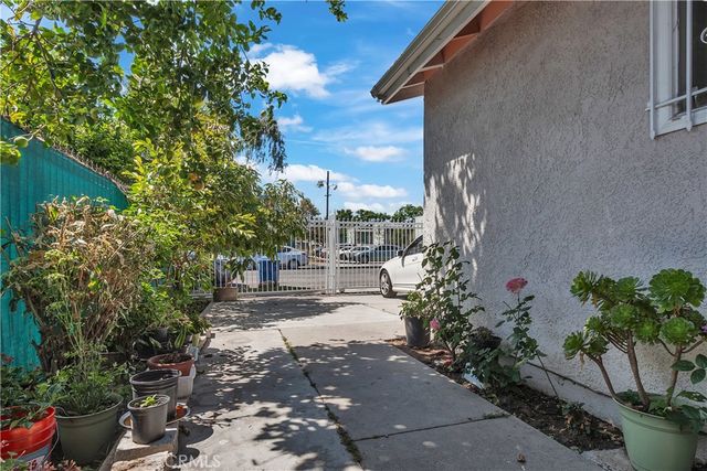 a view of a pathway of a house with a yard