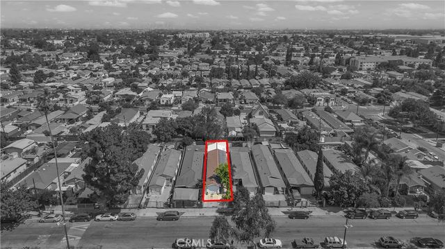 an aerial view of a houses with street