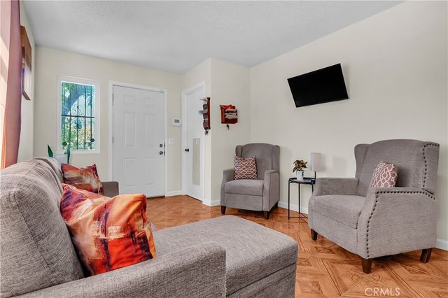 a bedroom with furniture and a flat screen tv