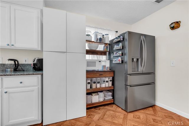 a kitchen with stainless steel appliances a refrigerator and a stove top oven