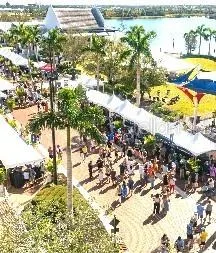 a vase of flowers sitting on a floor next to a yard