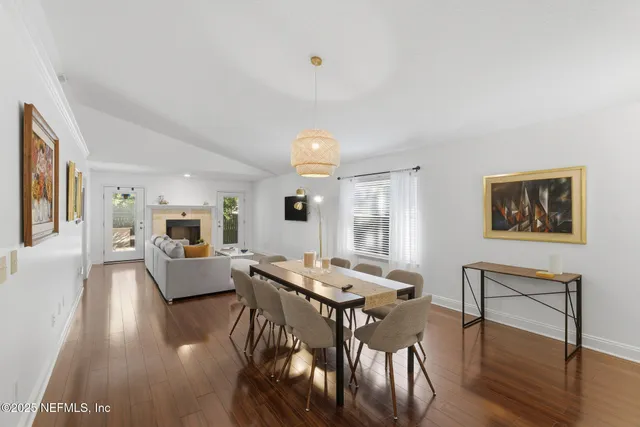a large kitchen with stainless steel appliances granite countertop a lot of counter space and wooden floors
