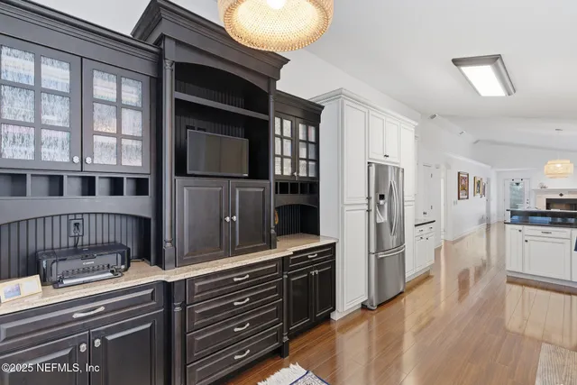 a view of a dining room with furniture wooden floor and a chandelier
