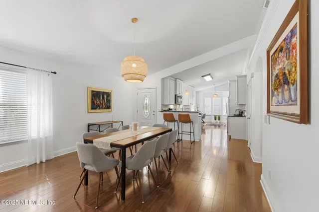 a bedroom with a bed a lamp and a chandelier