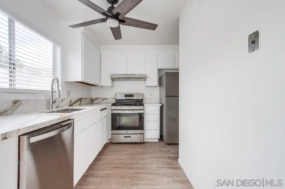 4178 Baycliff Way Oceanside, CA 92056 - Photo 14 of 27 a kitchen with a sink cabinets stainless steel appliances and a window