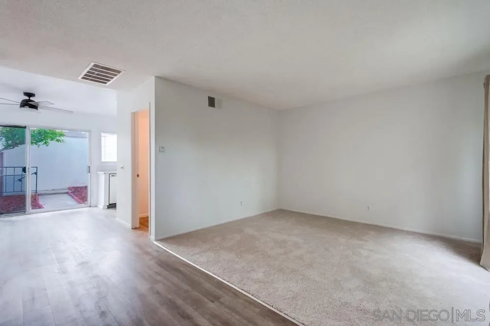 4178 Baycliff Way Oceanside, CA 92056 - Photo 4 of 27 an empty room with wooden floor and windows