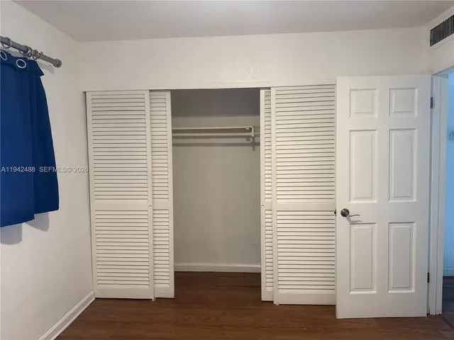 a bathroom with a granite countertop sink a toilet and a mirror