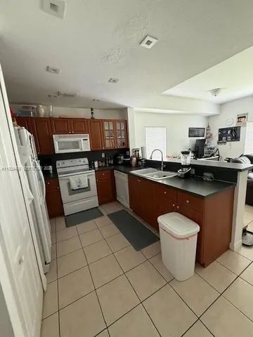 a kitchen with a sink and a stove top oven