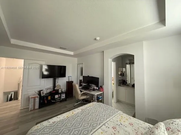 a bedroom with a bed and a flat screen tv
