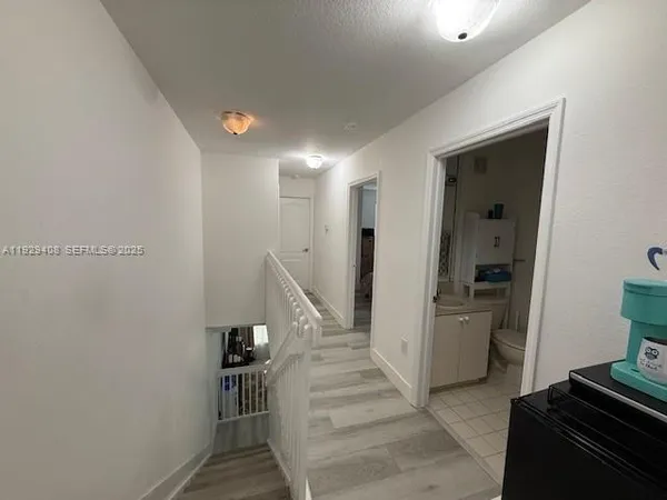 a view of entryway with furniture and wooden floor