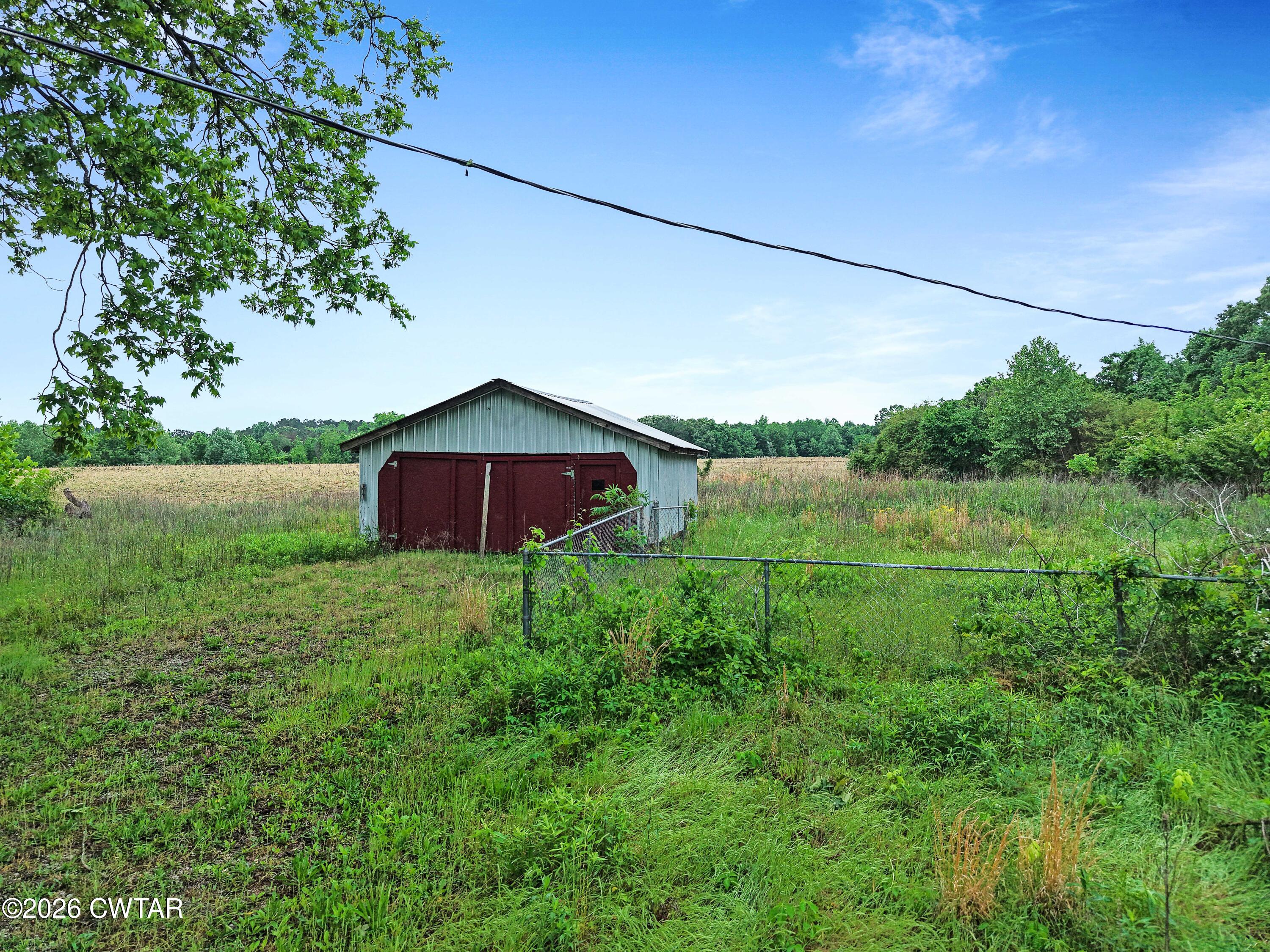 1525 Mill Creek Road Cedar Grove, TN 38321 - Photo 14 of 15 a view of a barn in the middle of a field