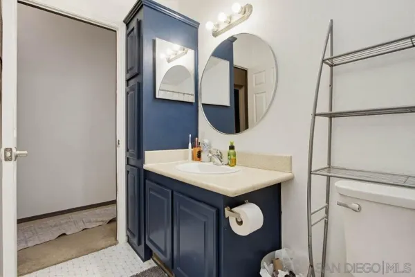a bathroom with a sink a vanity and a mirror