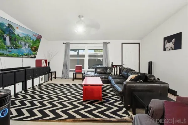 a living room with furniture and a floor to ceiling window