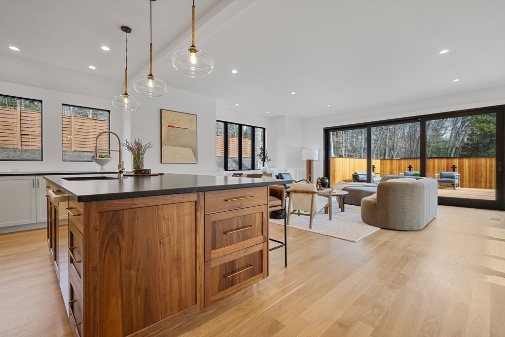 23 Dwight Road Needham, MA 02492 - Photo 11 of 40 a large kitchen with stainless steel appliances a large center island and a wooden floors