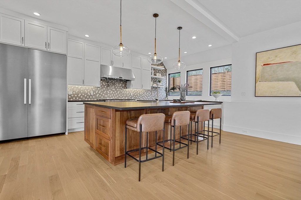 23 Dwight Road Needham, MA 02492 - Photo 12 of 40 a large kitchen with a table and chairs