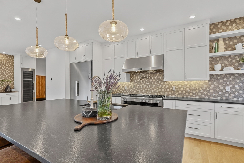 23 Dwight Road Needham, MA 02492 - Photo 14 of 40 a kitchen with stainless steel appliances granite countertop a stove a sink and a wooden cabinets