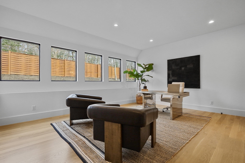 23 Dwight Road Needham, MA 02492 - Photo 20 of 40 a living room with furniture a flat screen tv and a large window