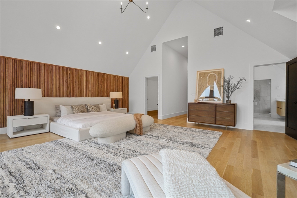 23 Dwight Road Needham, MA 02492 - Photo 24 of 40 a bedroom with a large bed and a couch