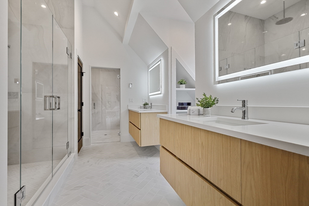 23 Dwight Road Needham, MA 02492 - Photo 25 of 40 a bathroom with a double vanity sink mirror and shower