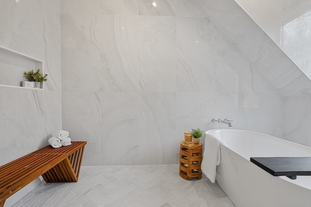 23 Dwight Road Needham, MA 02492 - Photo 27 of 40 a room with a table and couch