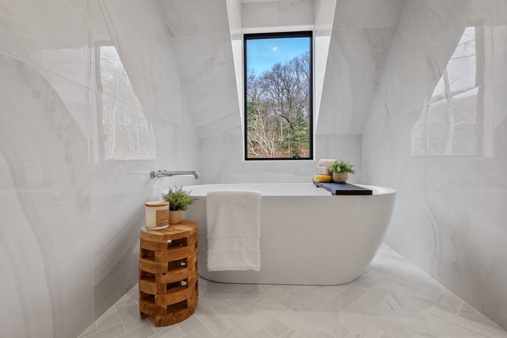 23 Dwight Road Needham, MA 02492 - Photo 28 of 40 a white bath tub sitting in a bathroom