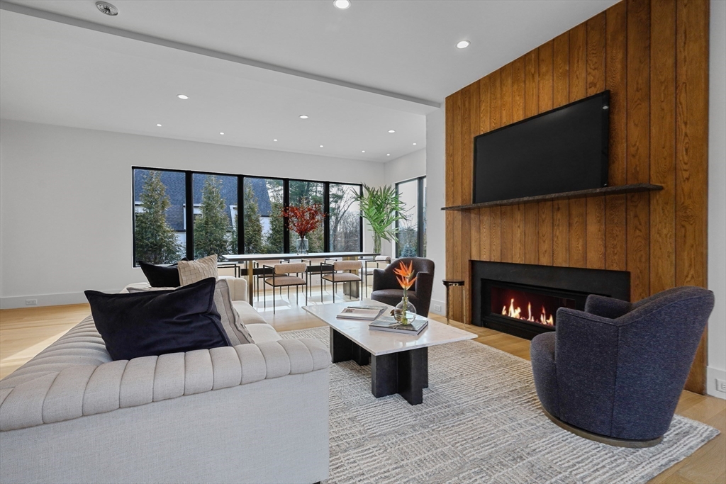 23 Dwight Road Needham, MA 02492 - Photo 7 of 40 a living room with fireplace furniture and a flat screen tv