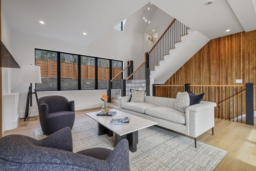 23 Dwight Road Needham, MA 02492 - Photo 8 of 40 a living room with furniture and a table