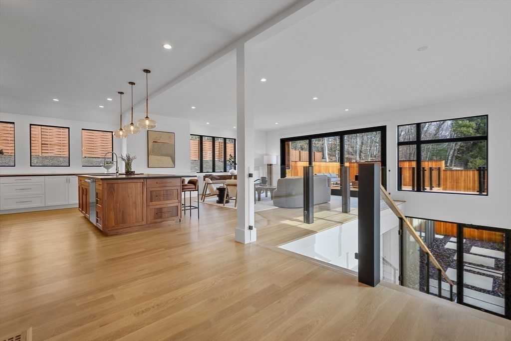 23 Dwight Road Needham, MA 02492 - Photo 10 of 40 wooden floor with dining room and kitchen view