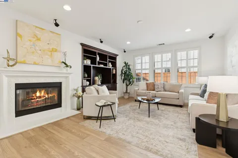 a living room with furniture and view of kitchen