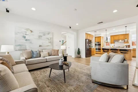 a kitchen with stainless steel appliances kitchen island granite countertop a sink and cabinets
